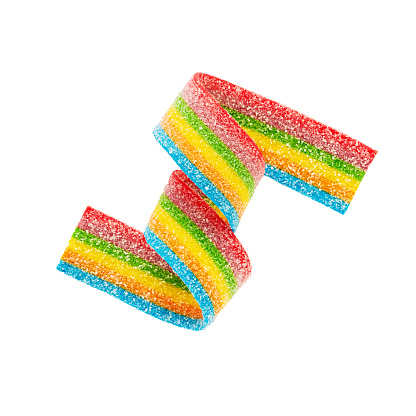 Rainbow sour jelly candy strip in sugar sprinkles isolated over white background. Top view
