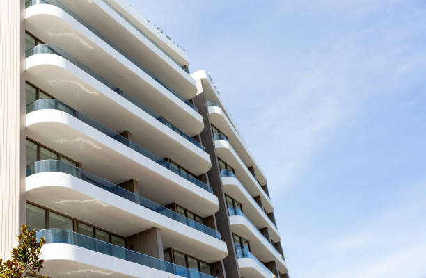 istock Low angle view of new, modern apartment building, sky background with copy space 1340790498