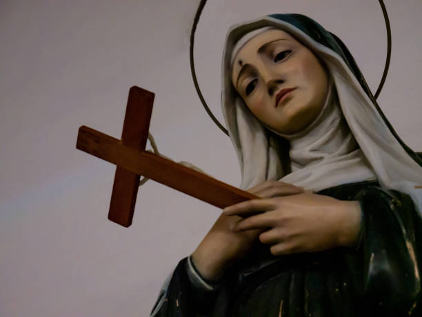 statue of the nun saint rita holding the cross of jesus christ statue of the nun saint rita holding the cross of jesus christ in her hand with a suffering look christian democratic union photos stock pictures, royalty-free photos & images