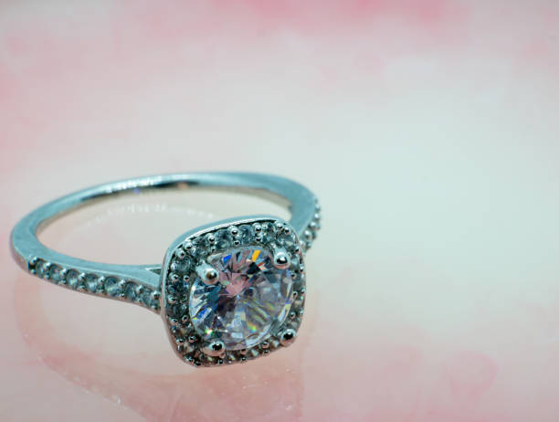 istock close-up photo silver diamond wedding ring on pink marble 1340792211