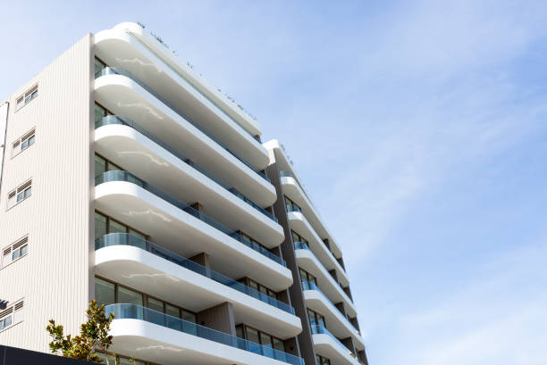 istock Low angle view of new, modern apartment building, sky background with copy space 1340792279
