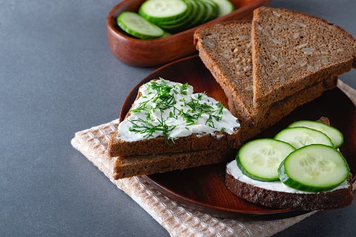 Sandwich with cottage cheese, cucumber and dill. Copy space.