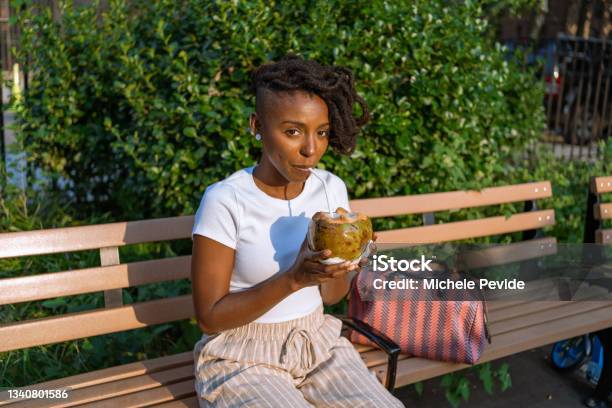 Black Woman Drinking A Natural Coconut Water Outdoors Stock Photo - Download Image Now