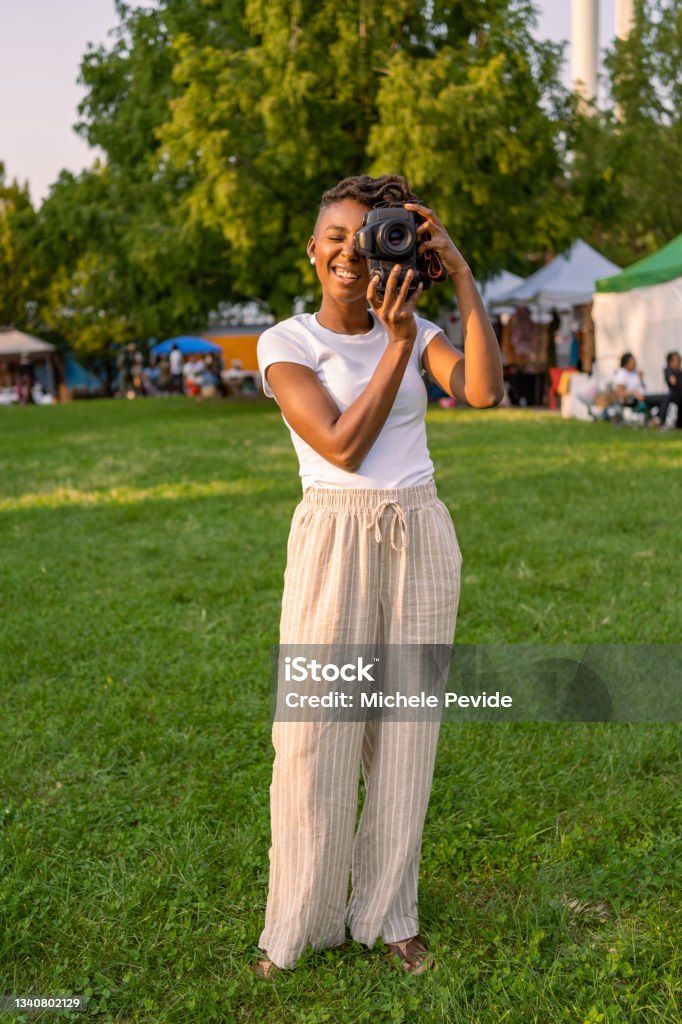 Black woman photographing outdoors 30-34 Years Stock Photo