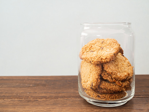 Oatmeal cookies in a glass bowl on a white background. Top view. Healthy food, healthy lifestyle.