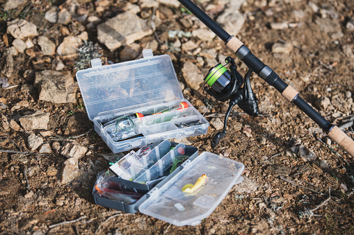 Fishing lures and fishing rod on the ground