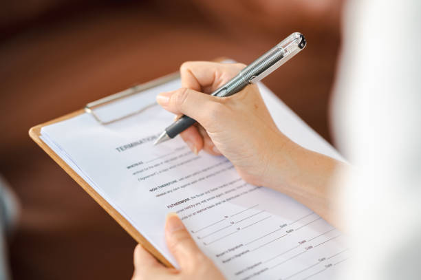 istock Psychologist making notes in medical history while understanding problems of a woman patient 1340812332