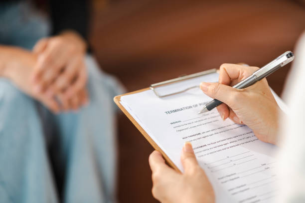 istock Psychologist making notes in medical history while understanding problems of a woman patient 1340812343