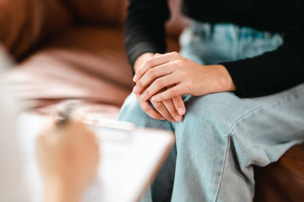 istock Psychologist making notes in medical history while understanding problems of a woman patient 1340812345
