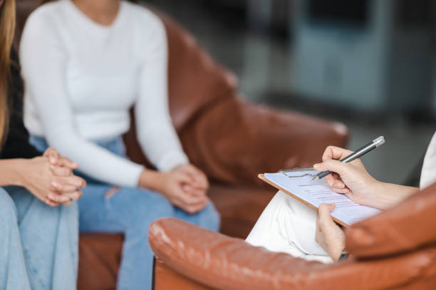 istock Psychologist making notes in medical history while understanding problems of a woman patient 1340812365
