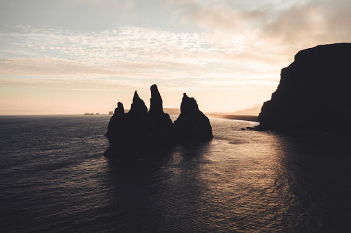 Iceland Reynisdrangar Sea Stacks Drone Point of View Stiched Sunset Panorama Shot from Vik i Myrdal drone flight towards the North Atlantic Ocean. Moody atmospheric summer twilight sunset skyscape. Reynisdrangar Sea Stacks, Vik i Myrdal, South Central Iceland, Iceland, Nordic Countries, Europe