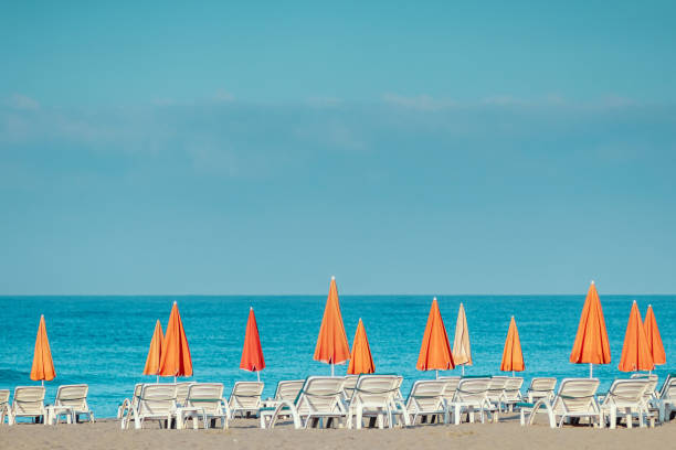 istock Morning sea, beach, empty sun beds for vacationers. Vacation concept. 1340815028