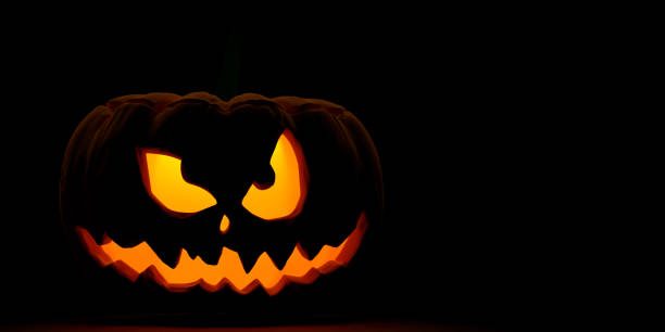 Halloween pumpkin looking at camera with large copy space.