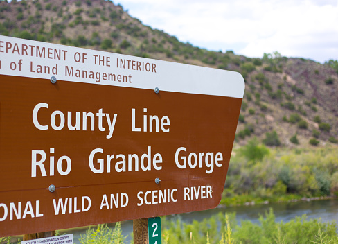 Embudo, NM: A sign reading “Rio Grande Gorge National Wild and Scenic River” in Embudo, a riverside village between Santa Fe and Taos.