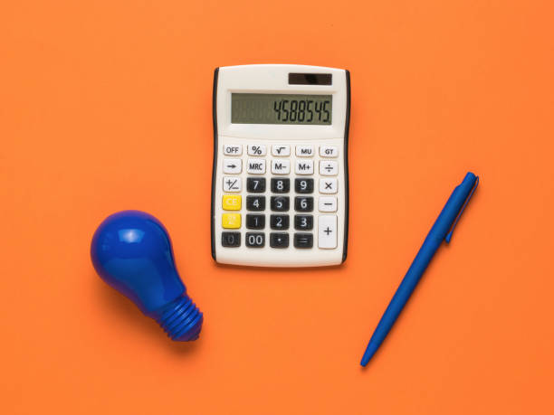 istock A blue light bulb, a blue pen and a calculator on an orange background. 1340825422