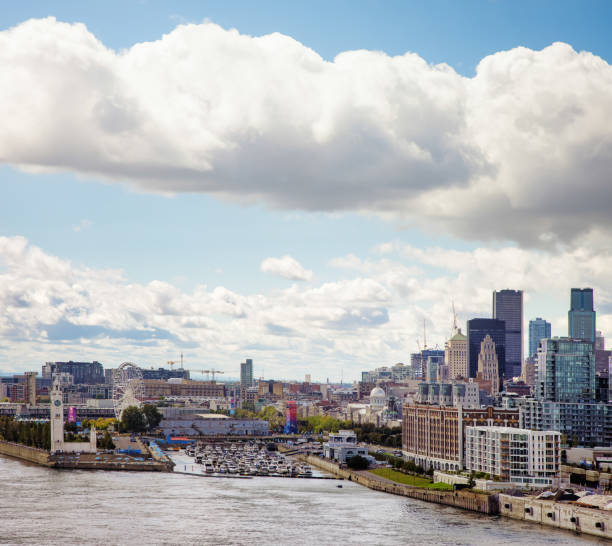 Montreal Harbor Skyline with partly cloudy sky and Saint-Lawrence river