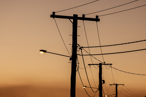 Silhouette Of Old Suburban Powerlines At Sunset