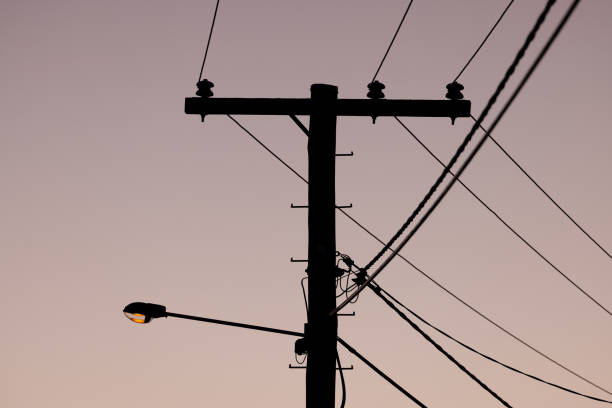 Silhouette Of High Voltage Powerlines At Dusk
