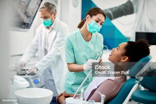 African American Woman Having Dental Treatment At Dentists Office Stock Photo - Download Image Now