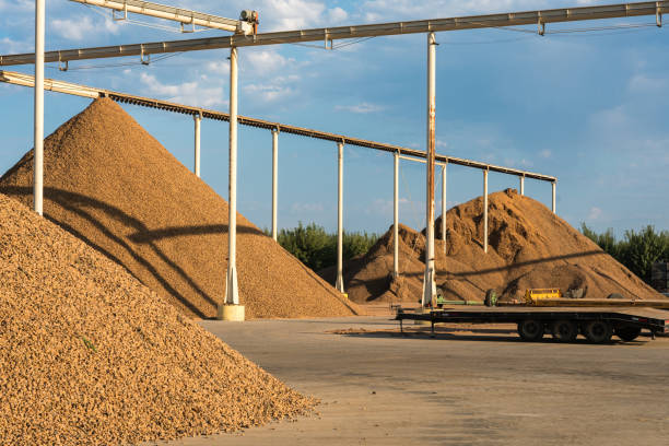 istock Dramatic image of a almond processing plant with heaps of almond shells piled high in Modesto, California. 1340833655