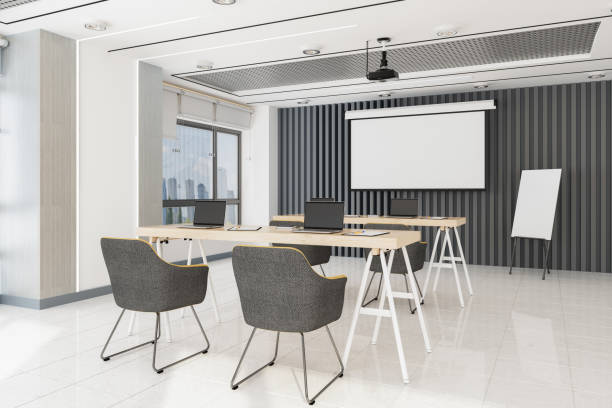 Modern Office Seminar Room With Projection Equipment, Whiteboard, Tables, Laptops And Chairs Modern Office Seminar Room With Projection Equipment, Whiteboard, Tables, Laptops And Chairs empty desk in classroom stock pictures, royalty-free photos & images