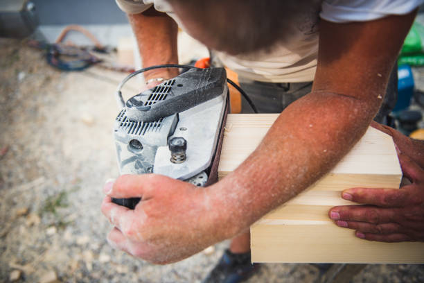 istock Manual worker sanding wood roof beam 1340837105