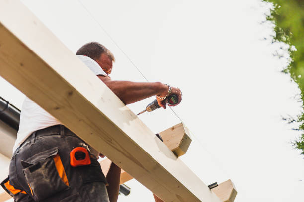 istock Construction worker on the wooden frame of a roof 1340837109