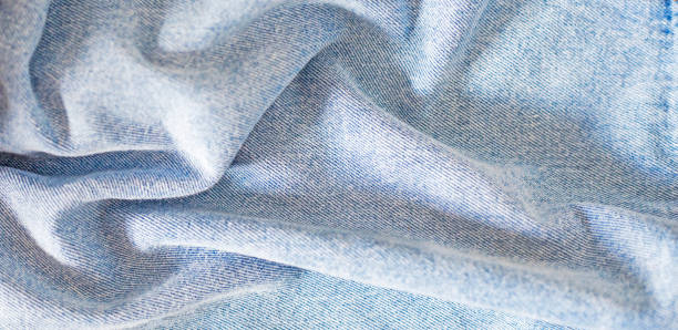 istock crumpled coarse denim light blue fabric, texture of matter, horizontal 1340839215