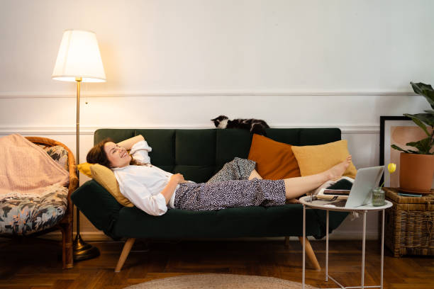 istock Young Woman Relaxing while Lying on Couch at Home 1340841692