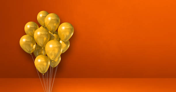 istock Yellow balloons bunch on orange wall background. Horizontal banner. 1340845766