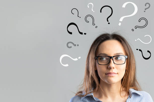 istock Question marks with young business woman 1340848704