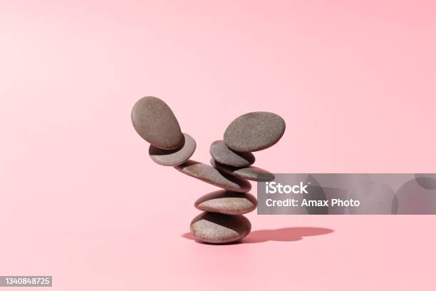 Concept Of Balance Of Gray Stones On A Pink Background Stock Photo - Download Image Now