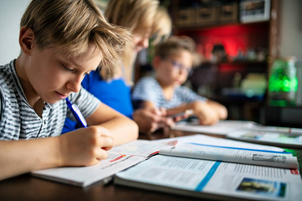 istock Mother helping her children to do the homework 1340849985