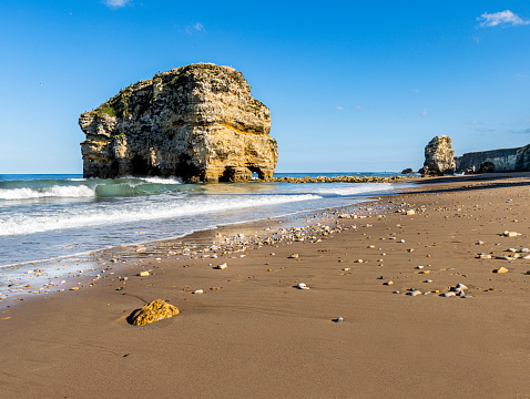Seascape of the famous coastal feature in South Shields, Marsden Rock, which is ever changing due to coastal erosion.