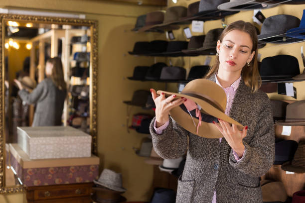 istock Woman choosing hat in store 1340852130