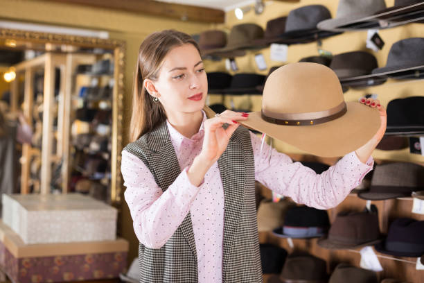 istock Woman choosing hat in store 1340852133