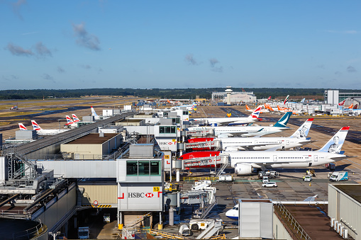 Madrid Bajaras, June 26, 2021: Long zoom view of airplanes on tarmac and iconic roof of Bajaras Airport in Madrid, Spain