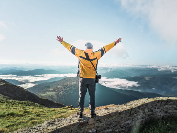 istock hiker man with camera taking picture of mountains 1340853033