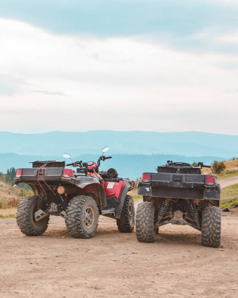 istock people riding on all terrain vehicle by mountains 1340853040