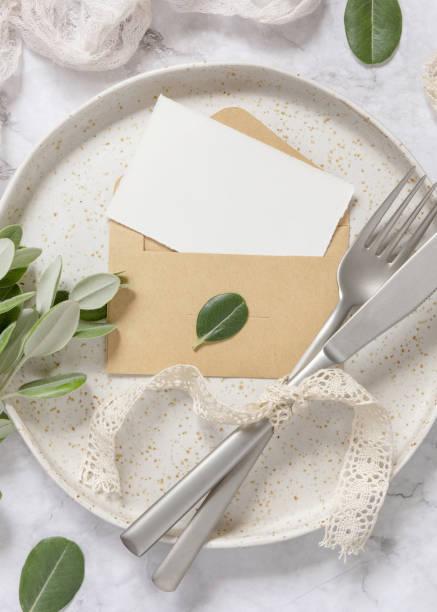 istock Blank paper card in envelope on plate with eucalyptus branches 1340855556