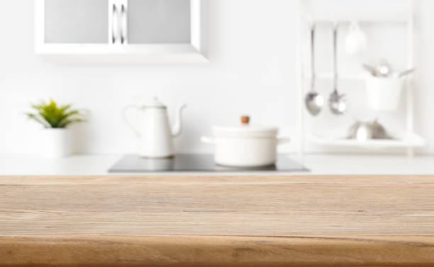 istock Blurred view of kitchen interior on background and wooden table 1340855917