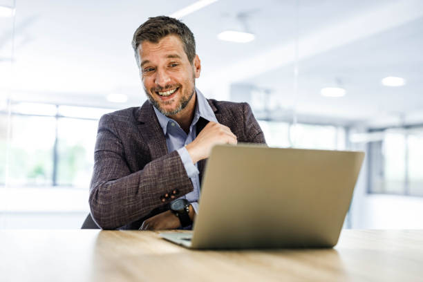 istock Happy businessman talking during conference call in the office. 1340855930