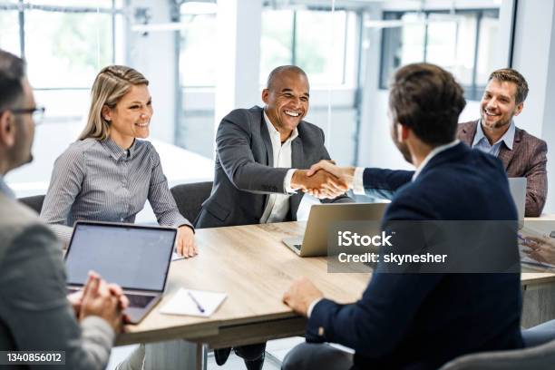 Happy Businessmen Shaking Hands On A Meeting In The Office Stock Photo - Download Image Now