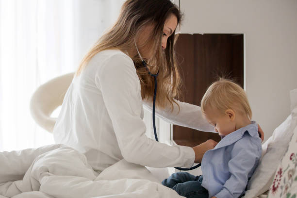 istock Young doctor, examining sick baby boy on a home visitation 1340858342