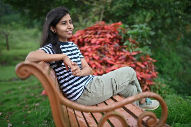istock Woman sitting in a lawn on a bench and relaxing 1340863263