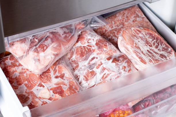 istock Raw frozen meat. Raw pork chops in the freezer. 1340863285