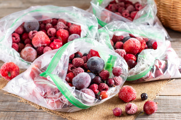 istock Frozen berries: black currant, red currant, blackberry, blueberry, raspberry, strawberry, cherry, plum in a plastic bag on a table. Frozen food. 1340863483