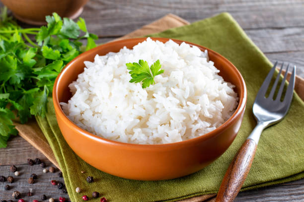 istock Cooked white rice garnished with parsley in a bowl (Selective Focus, Focus on the parsley and the rice around) 1340864486