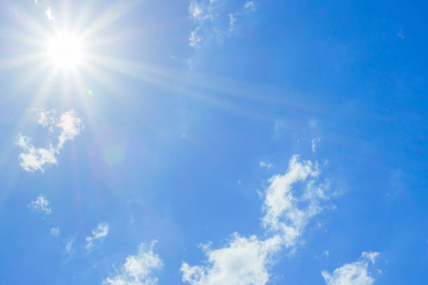 istock Bright sun with beautiful beams in the sky with light clouds 1340864646