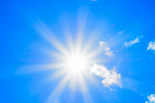 istock Bright sun with beautiful beams in the sky with light clouds 1340864698